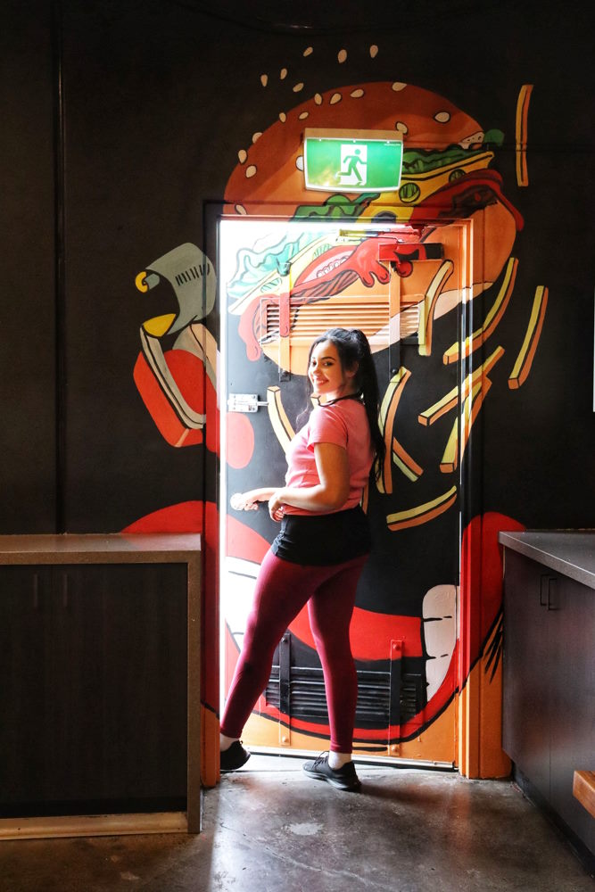 dina walking through a mural door dina gris studio artist melbourne